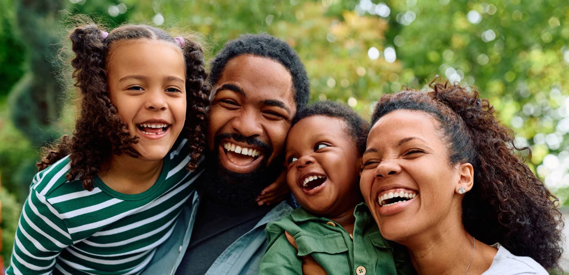 black family of four laughing
