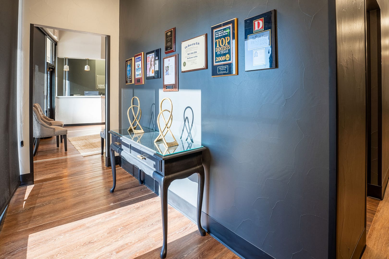 entryway with table and awards on the wall