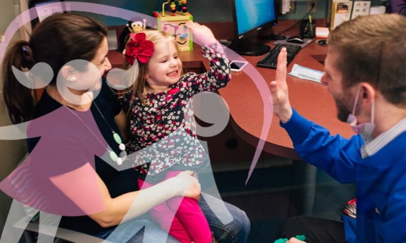 doctor high fiving with a young patient