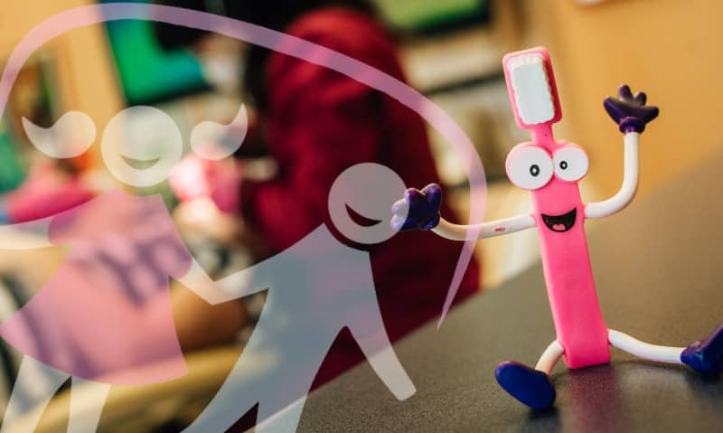 funny tooth brush with eyes and mouth and arms and legs