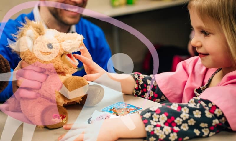 girl playing with stuffed animal