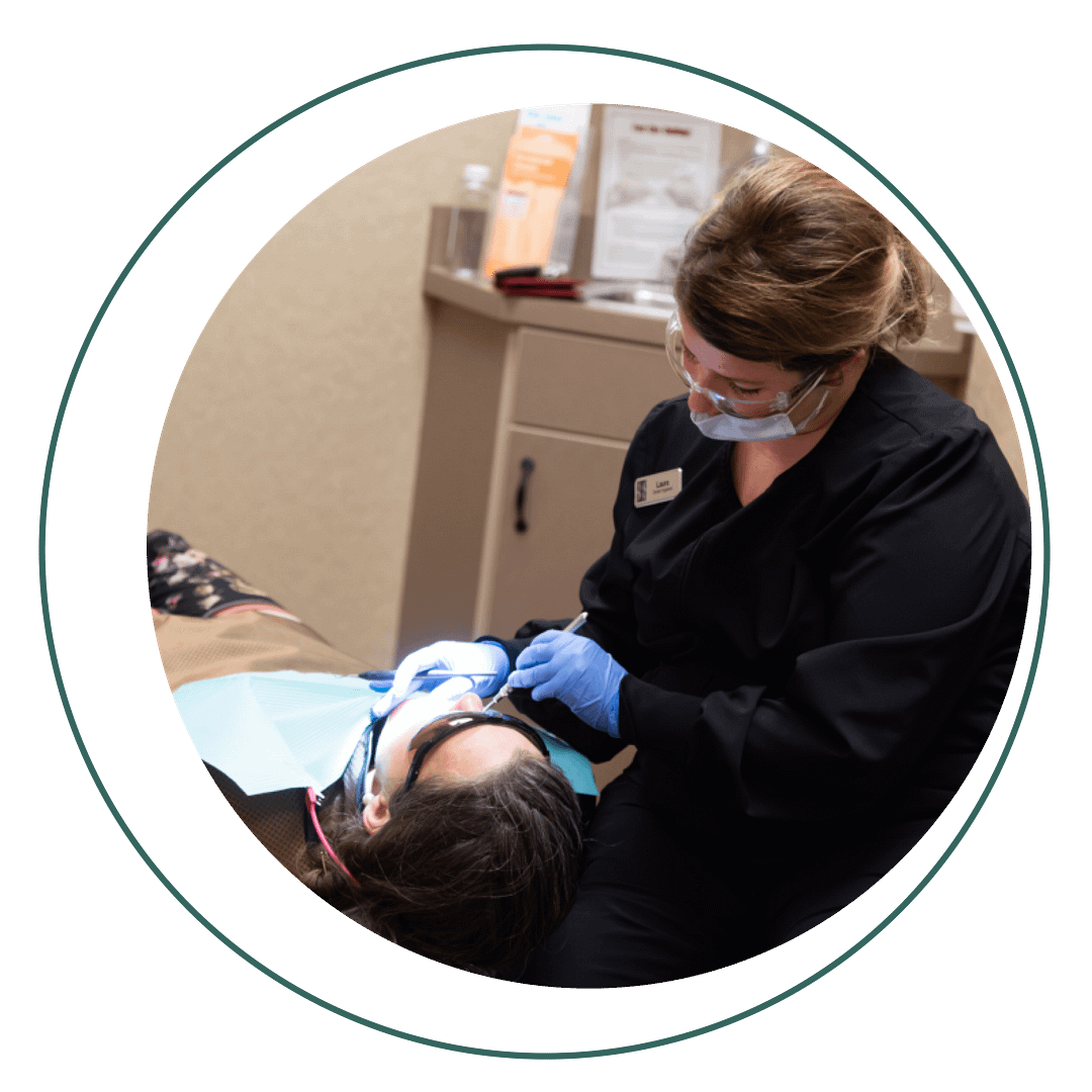 hygienist performing cleaning on patient
