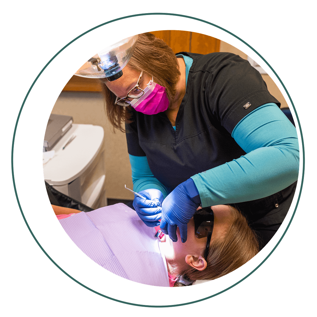hygienist performing cleaning on pediatric patient