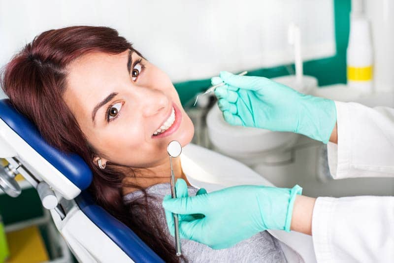 patient smiling in exam chair