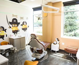 exam room with dental chair and minion decals on the wall