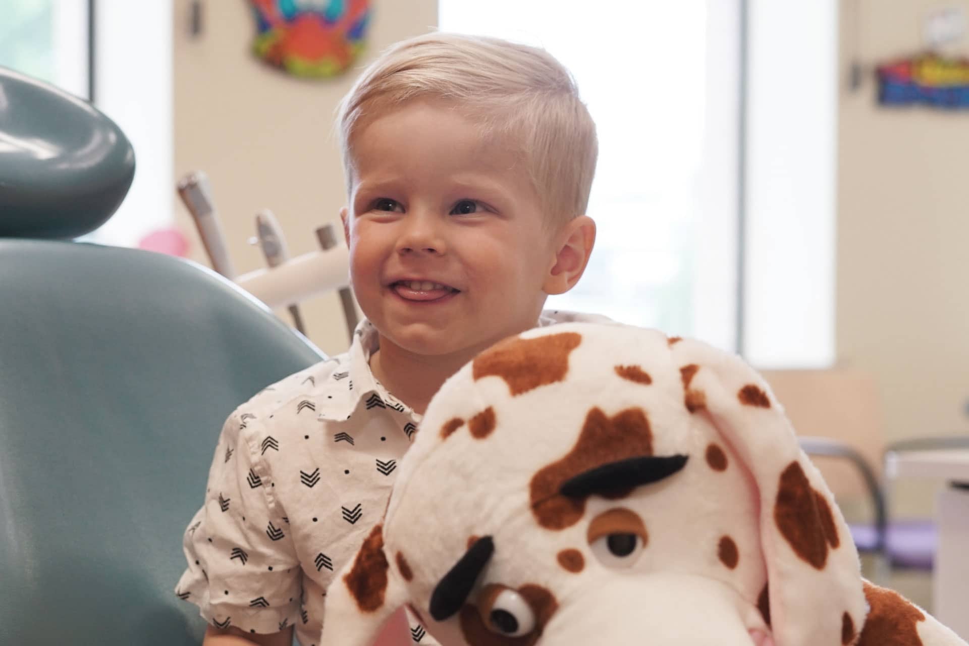 pediatric patient with stuffed animal in exam room