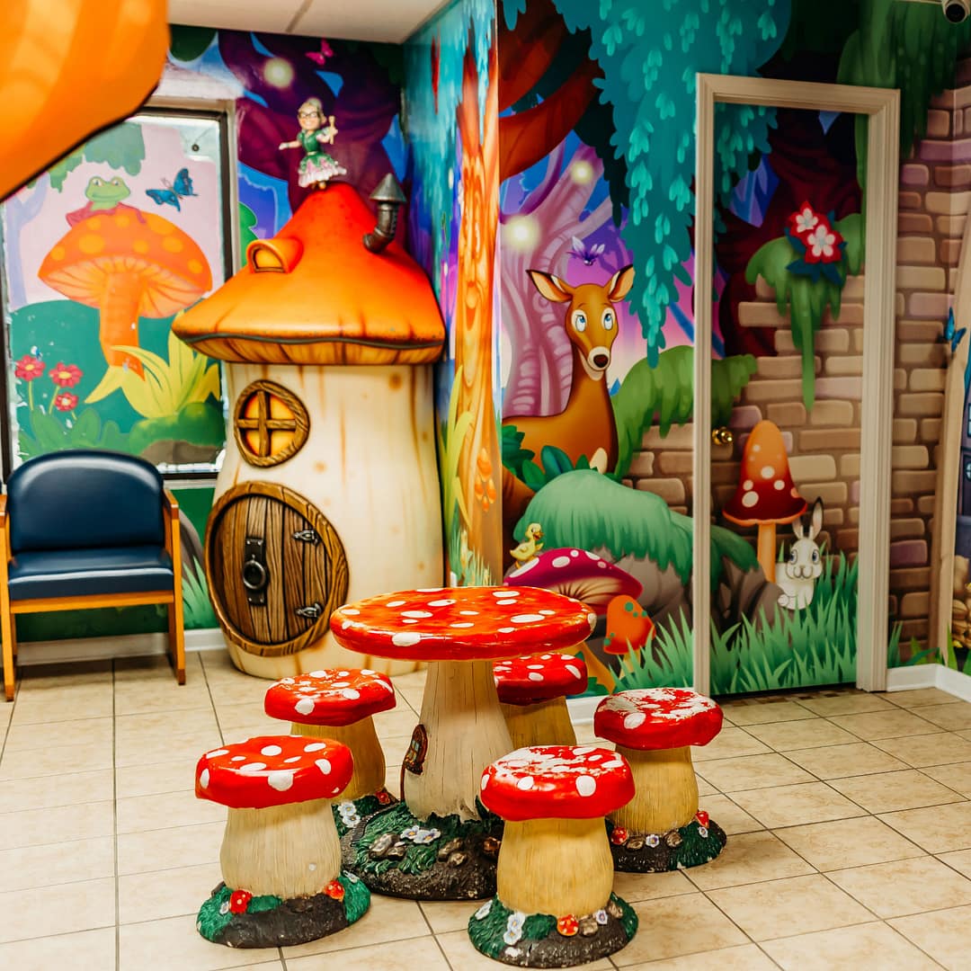 children's play area with fairy tale wall mural and mushroom table and stools