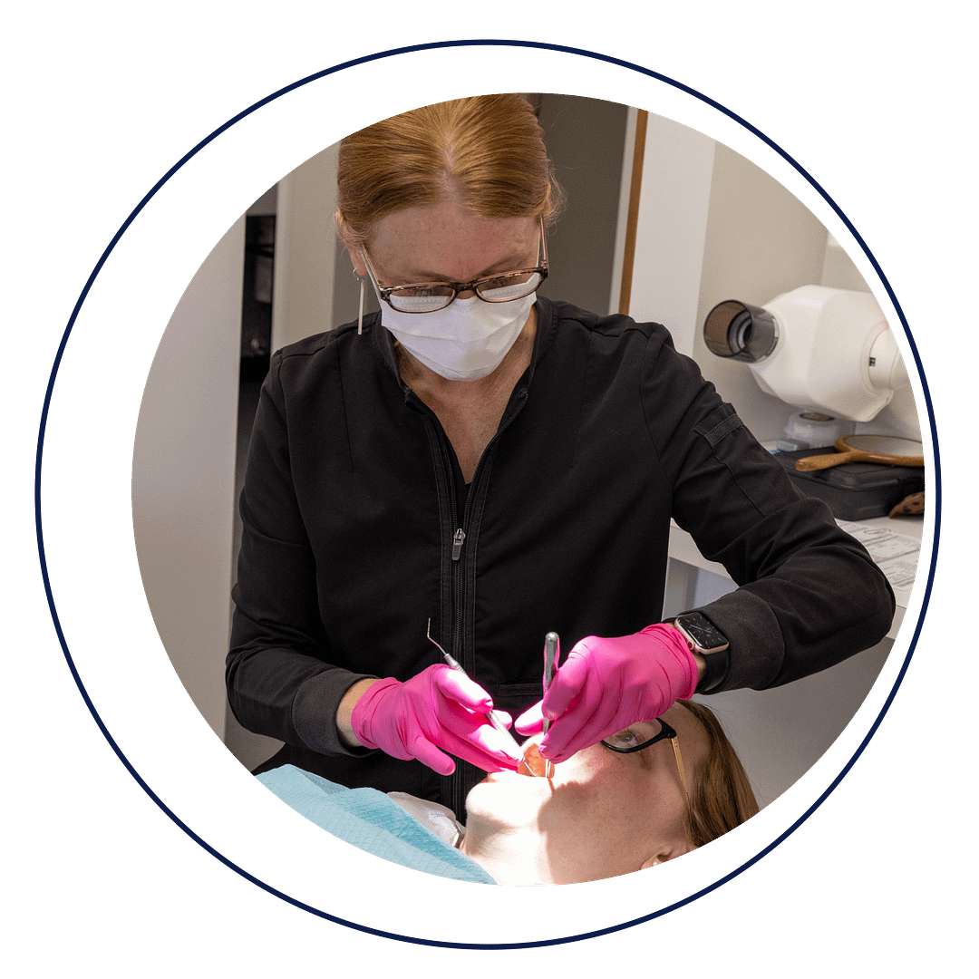 assistant performing dental procedure on patient