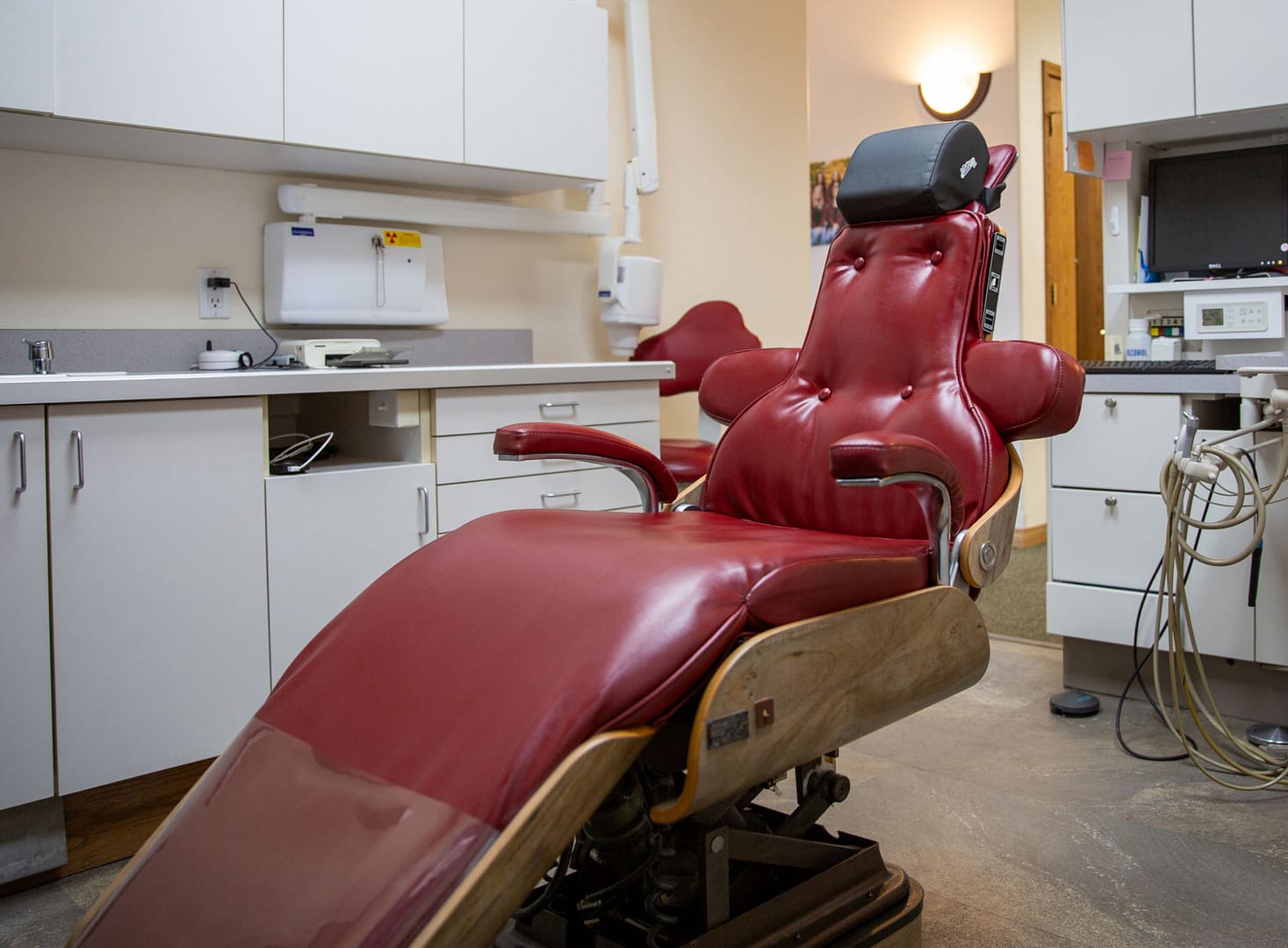 red dental chair in exam room
