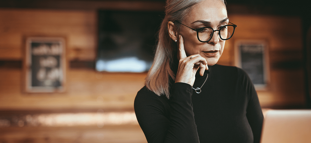 woman with glasses thinking
