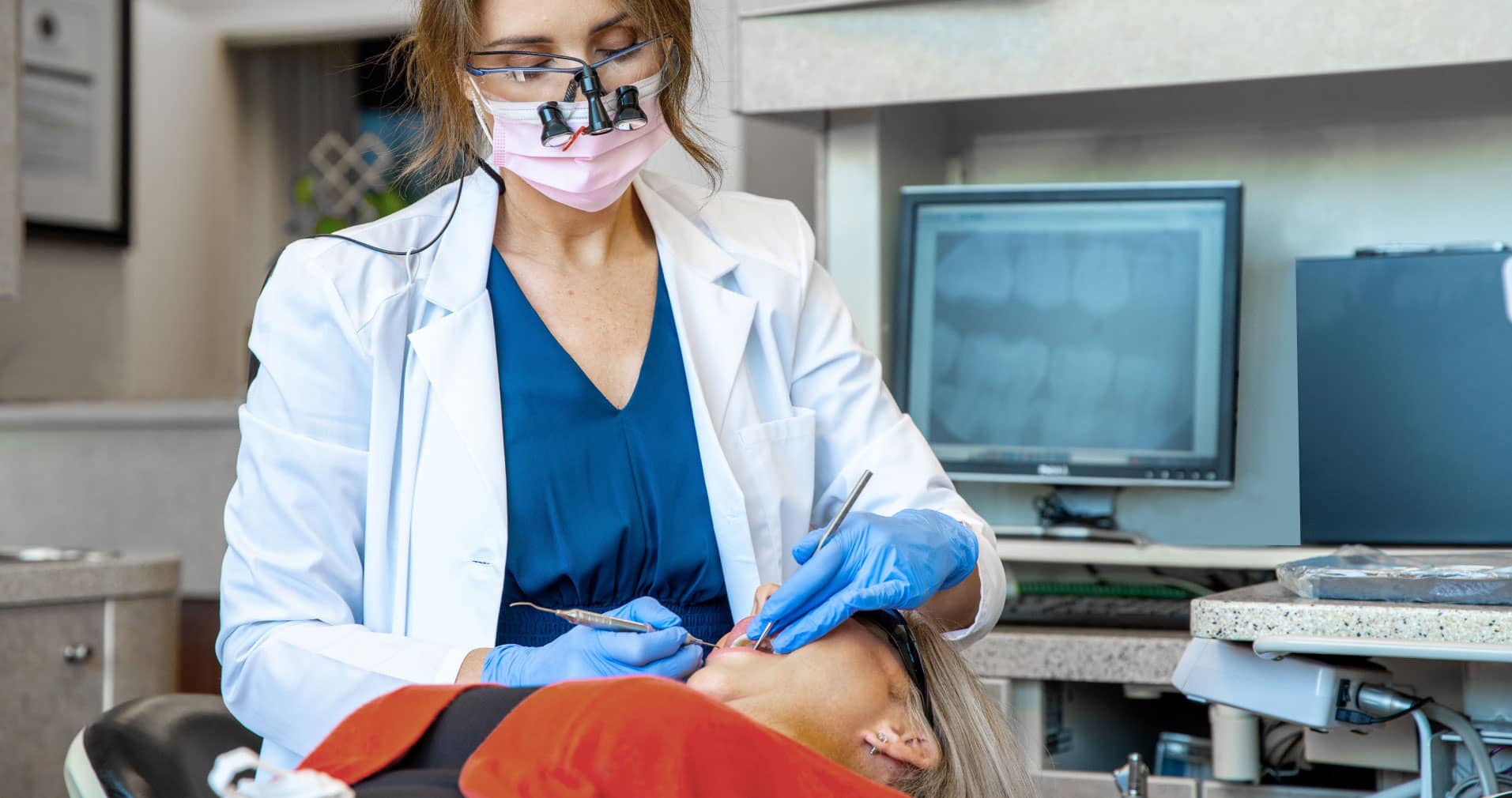 family-service-hero Dr. Maddox performing dental procedure on patient