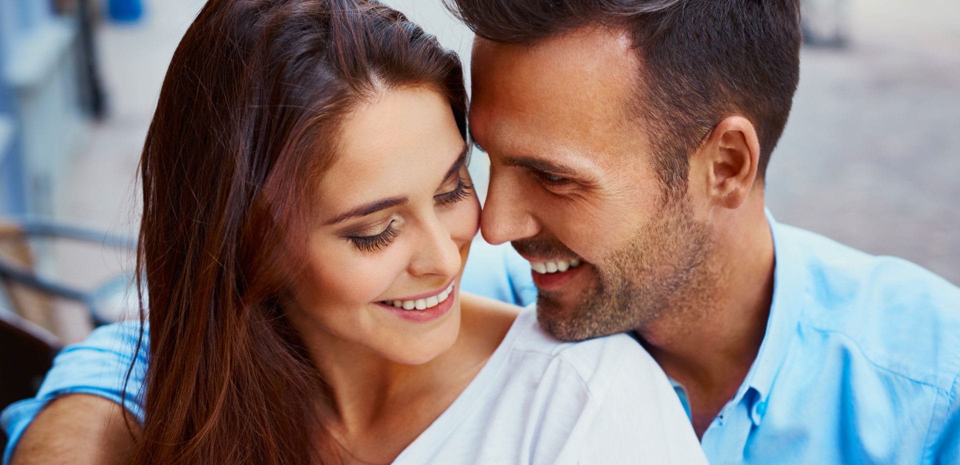 cosmetic-hero young couple smiling at each other while hugging
