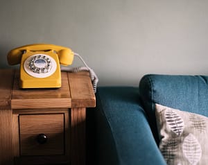 yellow old school rotary phone