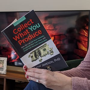 woman reading "Collect What you Produce" book