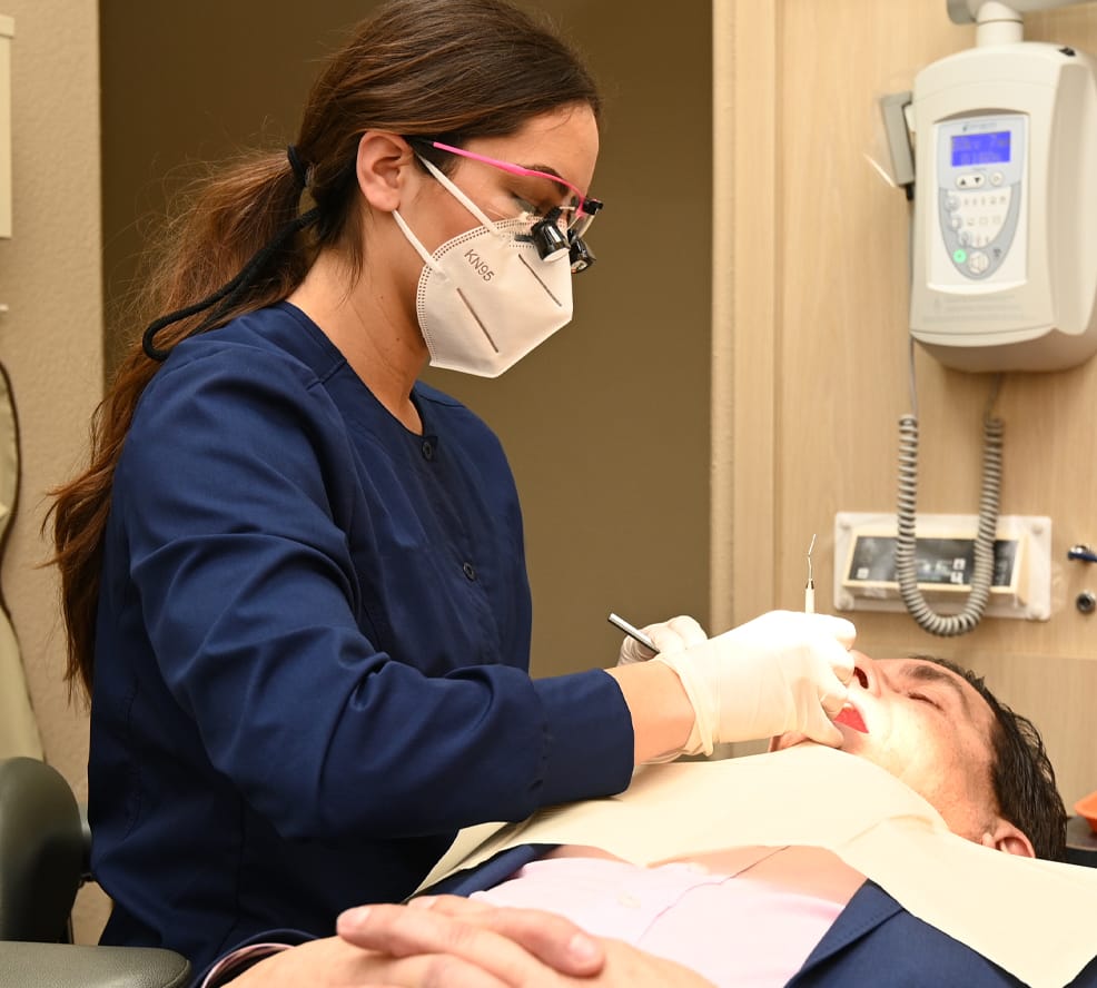 hygienist working with patient