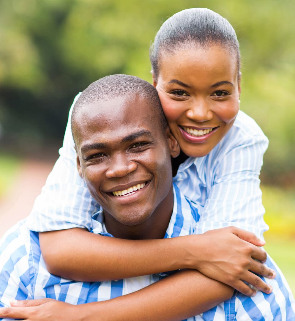 african american couple hugging and smiling at camera